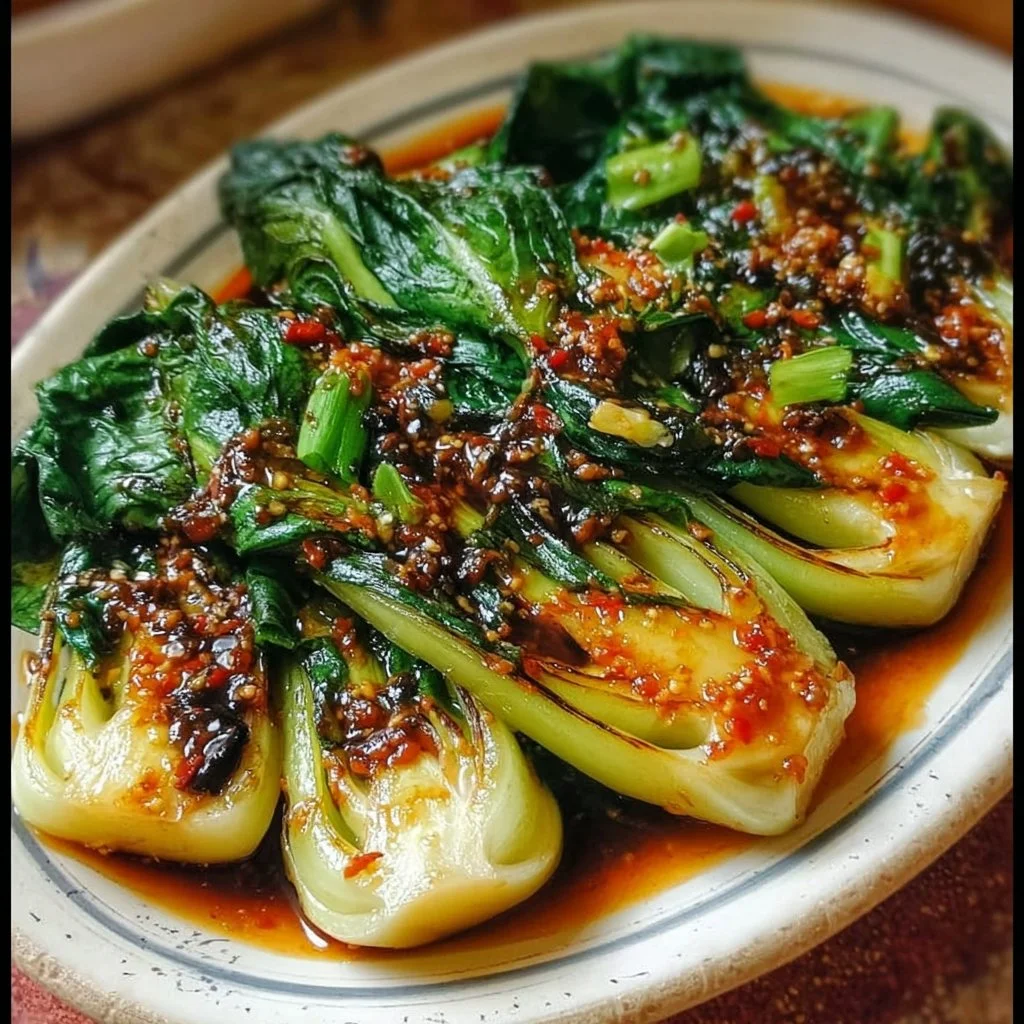 Bok Choy drizzled with ginger chili sauce on a plate