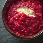 Delicious and vibrant raspberry dip served in a bowl with fresh raspberries.
