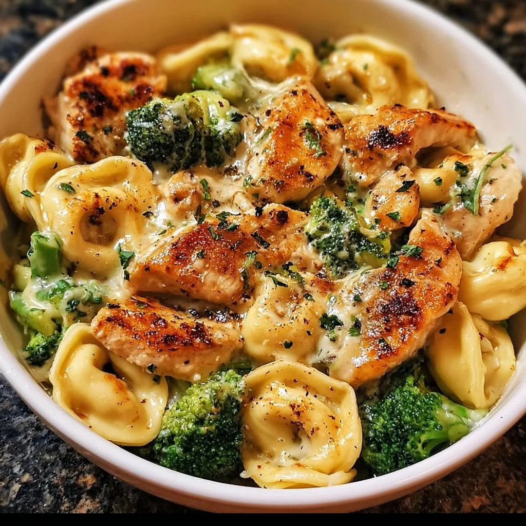 Creamy garlic parmesan tortellini with chicken and broccoli served in a bowl