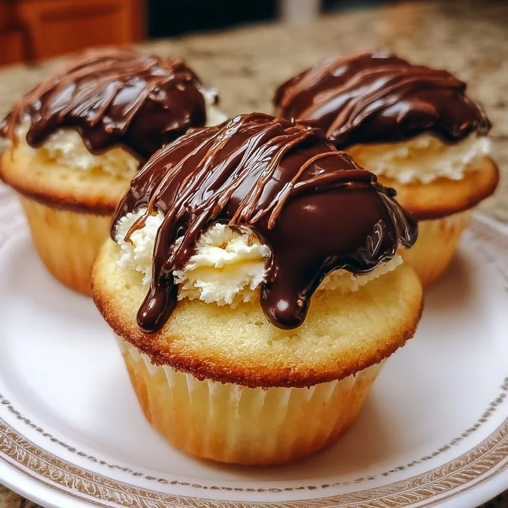 Decadent Heavenly Boston Cream Cupcakes with chocolate frosting and custard filling