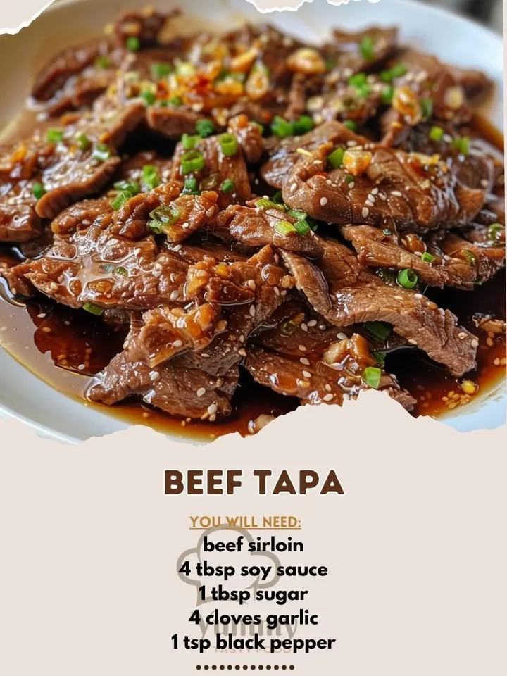 Plate of savory beef tapa garnished with herbs and served with rice