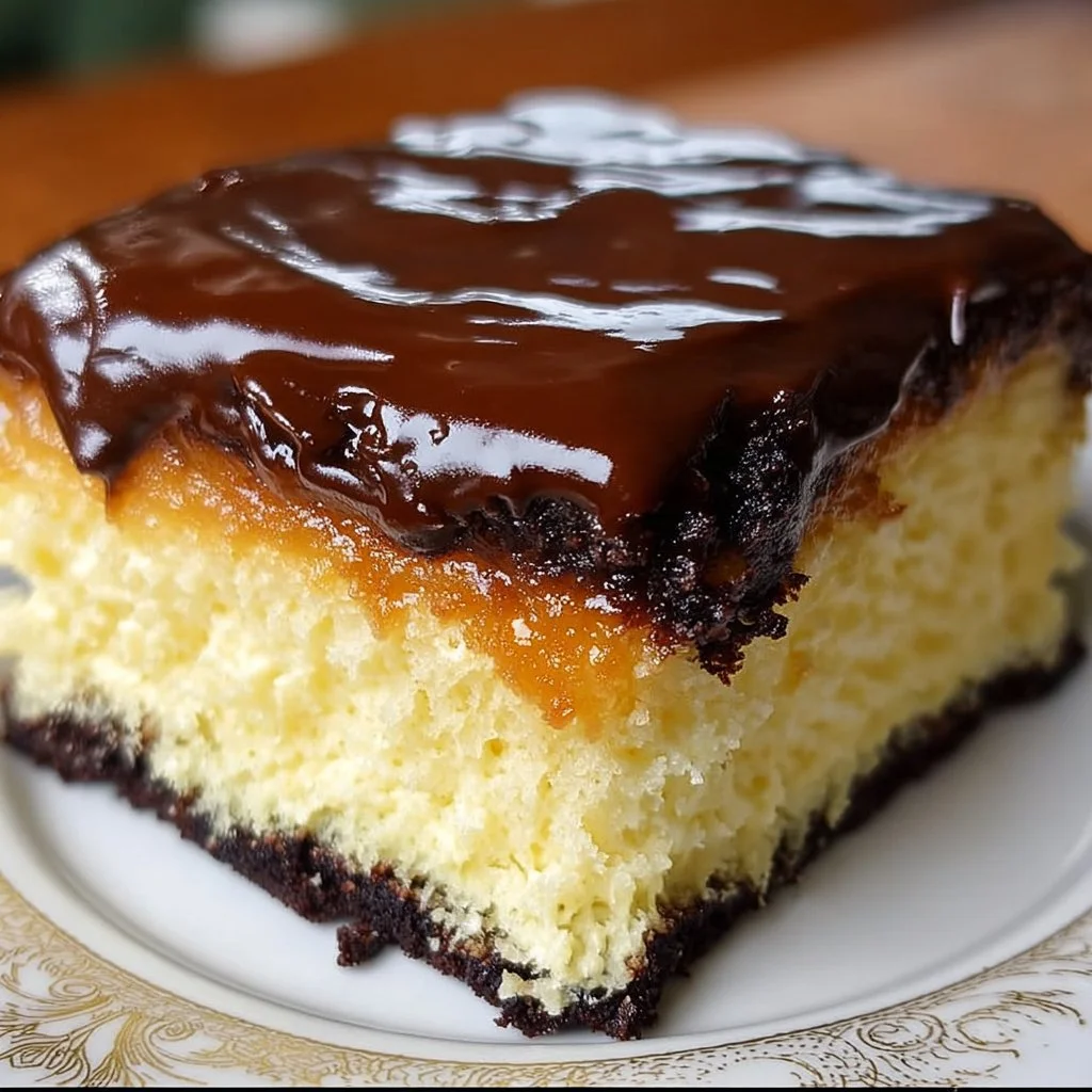 Delicious Boston Cream Poke Cake topped with chocolate and vanilla flavors.