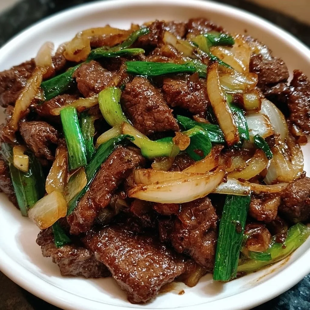 Savory Chinese beef stir fry with onions and vegetables served in a bowl