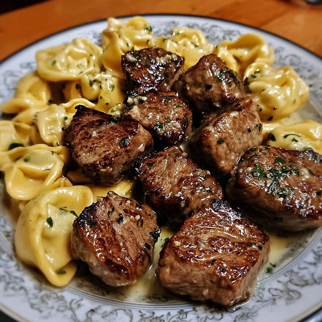 Delicious garlic butter steak bites served with creamy Alfredo tortellini