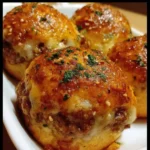 Garlic Parmesan Cheeseburger Bombs served on a plate with dipping sauce.