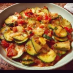 Delicious stewed Mexican zucchini served in a bowl with fresh herbs