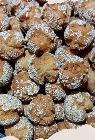 Homemade Binangkal doughnuts on a plate with powdered sugar