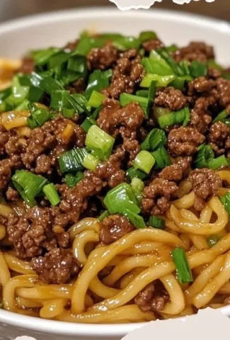 Plate of Mongolian Ground Beef Noodles garnished with green onions and sesame seeds