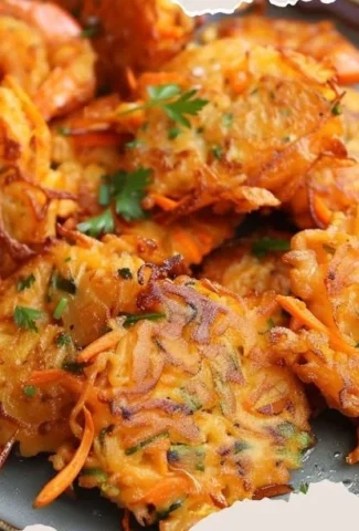 Delicious shrimp fritters served with dipping sauce on a plate