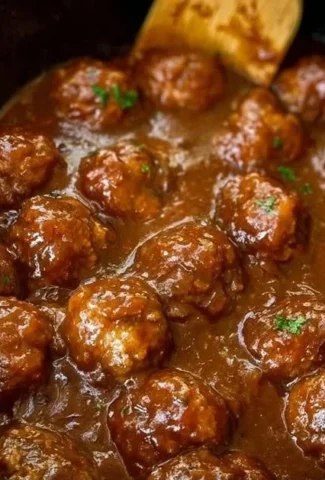 Slow Cooker Salisbury Steak Meatballs served on a plate with gravy and parsley.