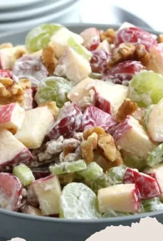 A colorful bowl of Waldorf Salad with apples, walnuts, and celery.